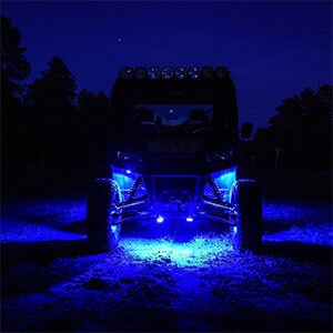 Image of the same off-road vehicle showcasing rock lights in blue.